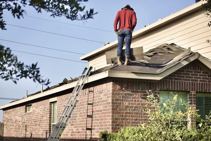 Professional roofer working on a residential roof in Mertztown